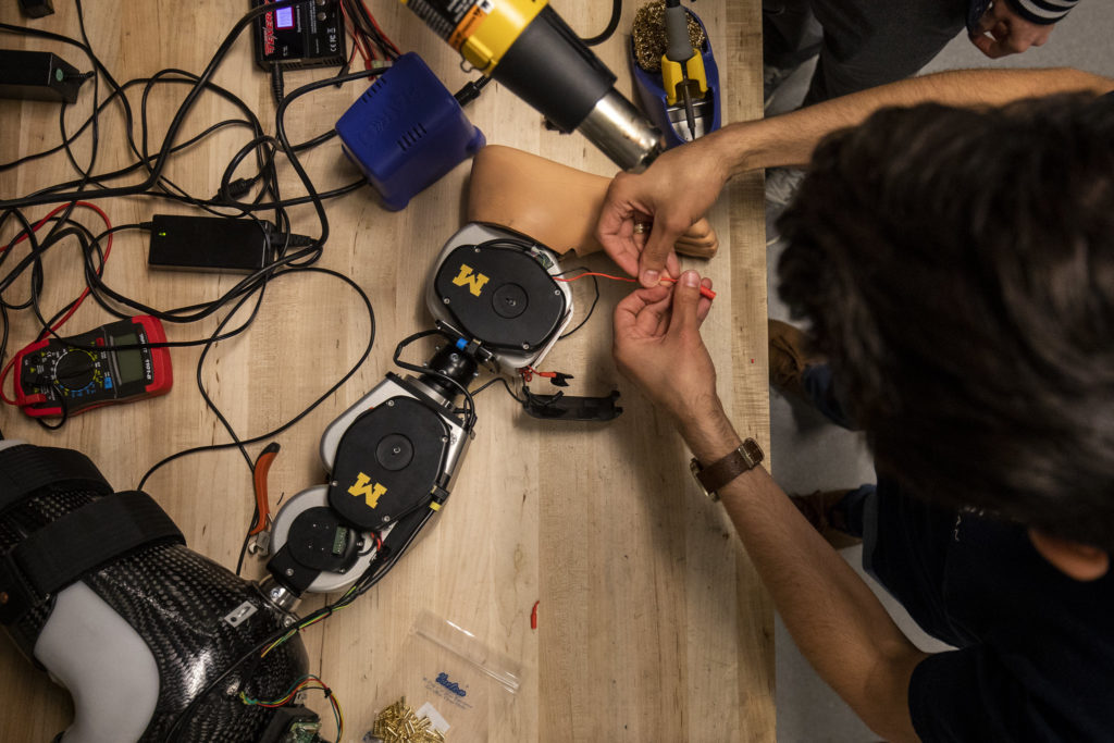 An open source leg on a table with wires and tools