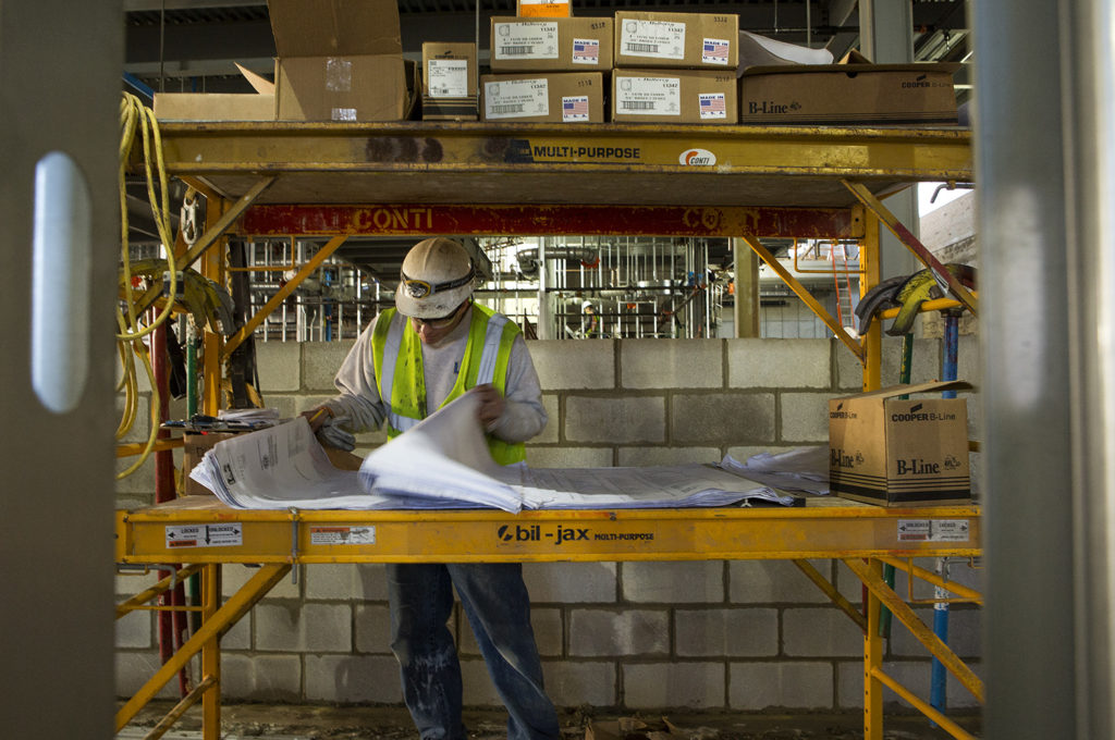 construction worker reads plans